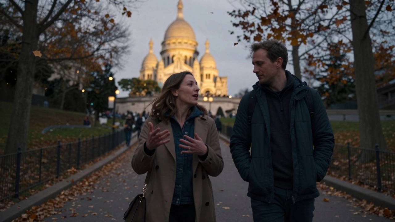 Two people walking peacefully through Montmartre at dusk with Sacré-Cœur in the distance.